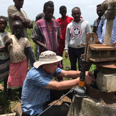 A WEFTA worker and local partners troubleshoot a groundwater well that provides water to Bachuma Hospital in West Omo Zone, Ethiopia.
