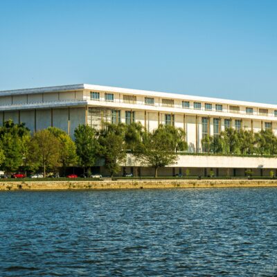 Credit: Mark Stebnicki, videographer/photographer for NC Farm Bureau (source: Pexels). Captivating view of the Kennedy Center beside the Potomac River with lush greenery in summer.